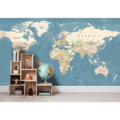 a blue and white world map with shelves in front of it, on the wall