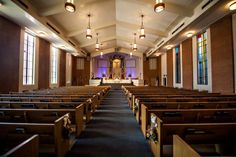 an empty church with pews and stained glass windows