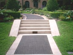 a driveway with steps leading up to a house