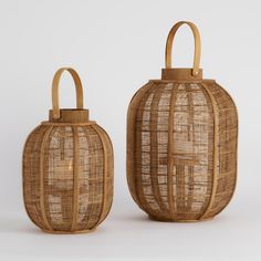 two rattan lanterns with wooden handles on white background