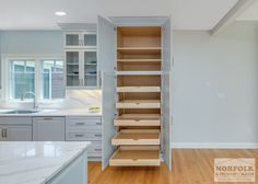 an open pantry in the middle of a kitchen