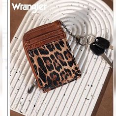 Introducing The Stylish And Functional Wrangler Leopard Print Zip Card Case! Measuring At 5" X 3.5" In Size, This Card Case Features A Trendy Leopard Print That Will Surely Make A Statement. It Has Two Credit Card Slots For Your Convenience And A Zip-Top Closure With Fabric Lining To Keep Your Cards Secure. The Iconic Wrangler Logo "W" Can Be Found On The Back, Adding A Touch Of Brand Recognition. Plus, It Comes With An Attached Split Key Ring So You Can Easily Carry It With You Wherever You Go. Brand Recognition, Phone Wallet, Zip Top, Christmas List, Card Case, Key Ring, Card Slots, Slots, Wallets