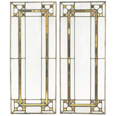 a pair of art deco mirrors with gold trimmings and glass panels on each side