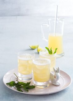 two glasses filled with lemonade sit on a plate