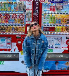 a woman standing in front of a vending machine