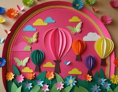 an image of paper art with flowers and hot air balloons