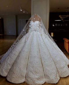 a wedding dress on display in a room