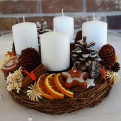 a basket filled with candles and fruit on top of a table