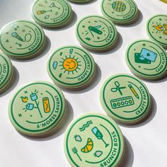 several green badges are arranged on a white surface