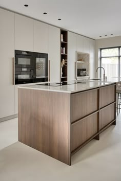 a modern kitchen with an island in the middle