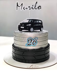 a cake with a car on top of it and the number 26 written in blue