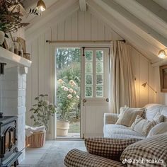 a living room filled with furniture and a fire place in front of a door that leads to a patio