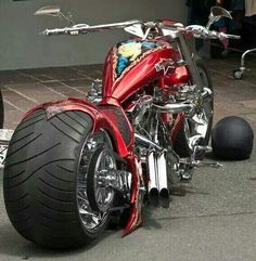 a red motorcycle is parked on the street