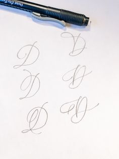 the letters are written in cursive writing on paper with a pen next to it