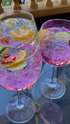 two wine glasses filled with different types of drinks