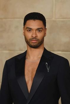 a man in a tuxedo poses for the camera