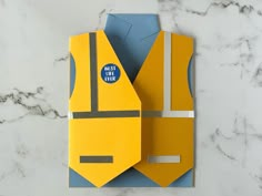 an origami construction worker vest is displayed on a marble countertop with the words best dad ever printed on it