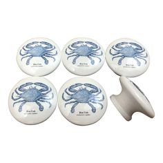 four blue crabs on white ceramic knobs