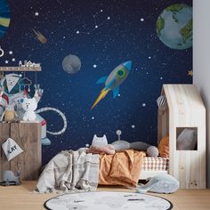 a child's bedroom with space themed wallpaper and toys on the floor in front of it