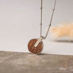 Opacity Necklace (Walnut/Silver) | Holzkern Sterling Silver Pendant With Adjustable Length, Sterling Silver Pendant Jewelry With Adjustable Length, Trendy Round Jewelry As Gift, Trendy Round Jewelry For Gift, Trendy Silver Circle Jewelry, Trendy Silver Circular Jewelry, Trendy Round Jewelry For Gifts, Adjustable Round Metal Necklace, Minimalist Resizable Jewelry As Gift