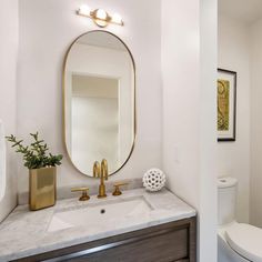 a bathroom with a sink, toilet and mirror