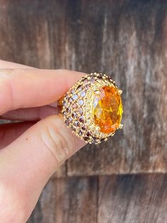 This stunning size 7 1/2 ring is very clean and shiny and in excellent condition. The band is gold toned and unmarked and the front is domed with a large, faceted center of golden orange surrounded by a border very tiny silvery rhinestones. The rest of the ring is covered in faceted rhinestones of dark golden brown and the sparkle of this ring is quite striking. The rhinestones have open backed settings as you can see from the interior. Long Black Gloves, Mystery Dinner, Costume Jewelry Rings, Jewelry Ring, Golden Brown, Warsaw, Star Earrings, Rings Statement, Costume Jewelry