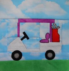 a patchwork piece with a golf cart on it