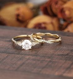 two wedding rings sitting on top of a wooden table