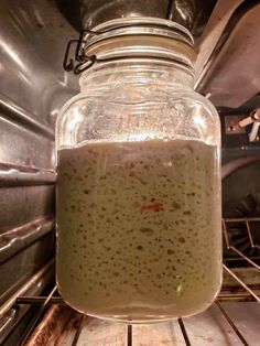 a glass jar filled with liquid sitting on top of an oven