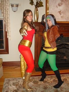 two women dressed in costumes standing next to each other on a rug near a fireplace