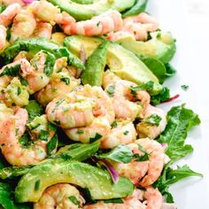 shrimp salad with avocado and cucumbers on a white platter, ready to be eaten