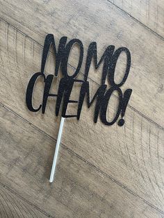 a cake topper that says nom chemo on it with a toothpick