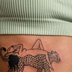 a woman laying on top of a cheetah tattoo