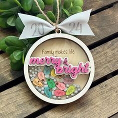 a wooden ornament with the words merry and bright hanging from a wood table