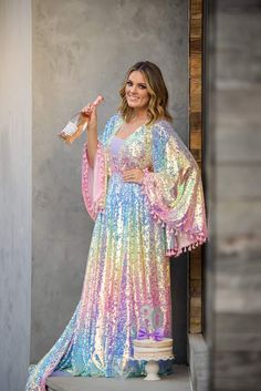 Our beautiful “Rainbow Disco" gown was designed after our own designers love for bohemian vibes and all things lace. This gorgeous gown is made with a beautiful pastel sequin fabric. We have added an elastic waist to the dress which adds extra sizing capabilities. Flair sleeves adorned with pink tassels. We have also added tassels to her back of bodice. This dress can easily size up and down. Dress comes with a detachable slip-Slip is exact measurements provided-so there is no give/stretch. You Up And Down Dress, Slip Dress Diy, Flair Sleeves, Rainbow Wedding Dress, Tie Dye Fashion, Fairytale Fashion, Bohemian Vibes, Rainbow Dress, Princess Outfits