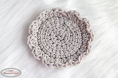 a crocheted dishcloth on a white fur surface