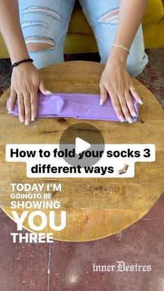 a woman sitting on top of a wooden table next to a purple object with the words, how to fold your socks 3 different ways today i'm going be showing you three