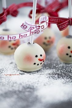 an image of some cake pops with frosting and decorations on them in the shape of snowmen