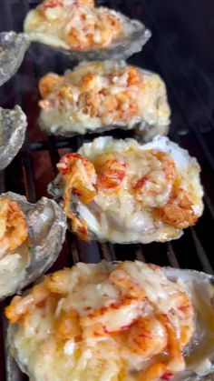 several oysters cooking on an open grill