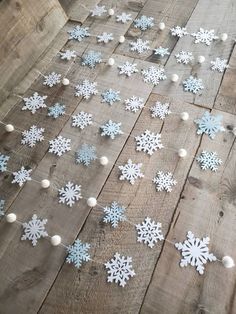 snowflakes are scattered on the wooden floor