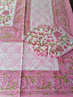 pink and gold table cloth with floral designs