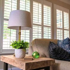 a living room with a couch, table and lamp in it's centerpiece