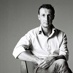 a black and white photo of a man sitting in a chair