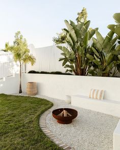 an outdoor fire pit in the middle of a garden