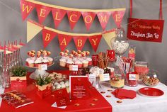 a baby shower is set up with candy and desserts for the guests to eat