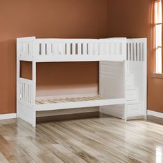 a white bunk bed sitting on top of a hard wood floor next to a window