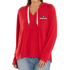 The Women's Red Georgia Bulldogs Christine Pullover Hoodie is the perfect way to show your support for the Georgia Bulldogs. Made from a lightweight blend of polyester, rayon, and spandex, this hoodie is ideal for mild temperatures. It features side splits at the bottom hem for a comfortable fit, side pockets for storage, and screen-printed graphics that proudly display your Georgia Bulldogs pride. The silver grommets add a stylish touch to this must-have hoodie for any Georgia Bulldogs fan. Red Fleece Top For Sports Events, Red Stretch Sweatshirt Sporty Style, Red Drawstring Hood Top For College, Sporty Hooded Tops In University Red, University Red Sporty Hoodie Top, Sporty University Red Hoodie Top, Red College Top With Drawstring Hood, Red Hooded Top For Fan Gear, Sporty University Red Hooded Top