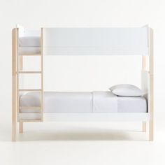 a white bunk bed with a ladder and pillows on the bottom level, against a white background