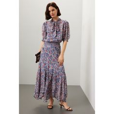 Blue floral cotton (100% Viscose). A-line. Short sleeves. Tie neck. Pull on. 53" from shoulder to hemline. Imported. Floral Print A-line Maxi Dress With Flowy Skirt, Floral Print A-line Flowy Maxi Dress, Flowy A-line Maxi Dress With Floral Print, Blue A-line Dress With Flowy Skirt, Knee-length Flowy Midi Dress With Floral Print, Knee-length Floral Midi Dress With Flowy Skirt, Spring Floral Print Fit And Flare Dress, Floral Print Midi Dress With Flowy Skirt, Floral Print Flowy Midi Dress