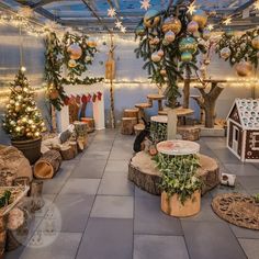 a room filled with lots of fake trees and christmas decorations on the walls, along with lights